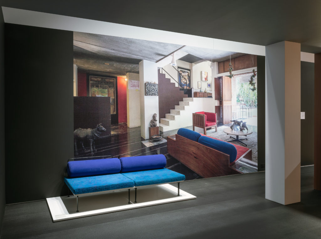 installation view of a blue couch and a wall mural with the couch in situ